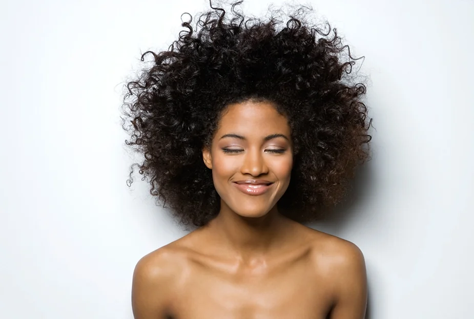 a woman with curly hair smiling