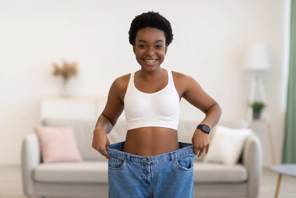 a woman wearing a white top and jeans