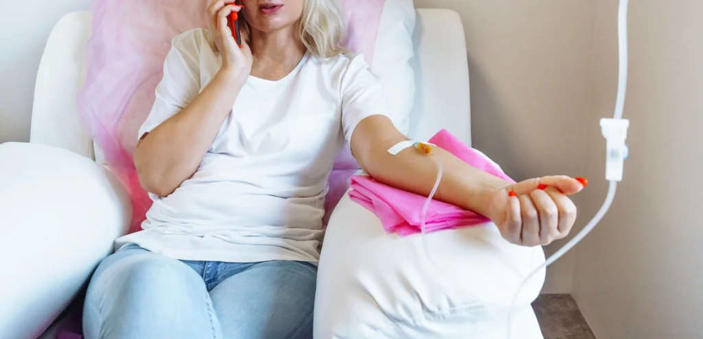 a woman sitting in a hospital bed talking on a phone